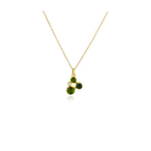 Three blue/green tourmalines, approximately 1.75 cttw, and a round diamond, .025 cts, in a "confetti" cluster with 18k yellow gold and 14k yellow gold behind stones. Pendant is on a 18'' long, 18k yellow gold chain and ranges from 5/8" -3/4" x 3/8" (16-19 x 10 mm) in size.