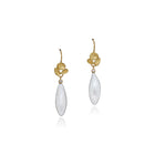Elongated drop-shaped white freshwater pearl drop earrings with small diamonds and triple shell cluster tops in 18k yellow gold, on French wires. Pearl drops are 7/8" x 5/16" (21 x 8mm) and total length is 19/16" (40mm). 