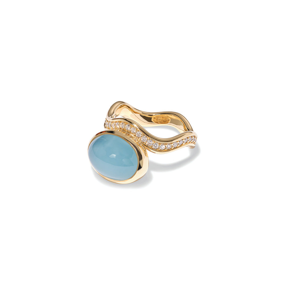 Aurora ring in 18k yellow gold with an oval aquamarine cabochon offset on a wavy pavé-set diamond band with vs white diamonds, 0.52 cttw. Ring is 5/8" wide (15mm) and is a size 7.