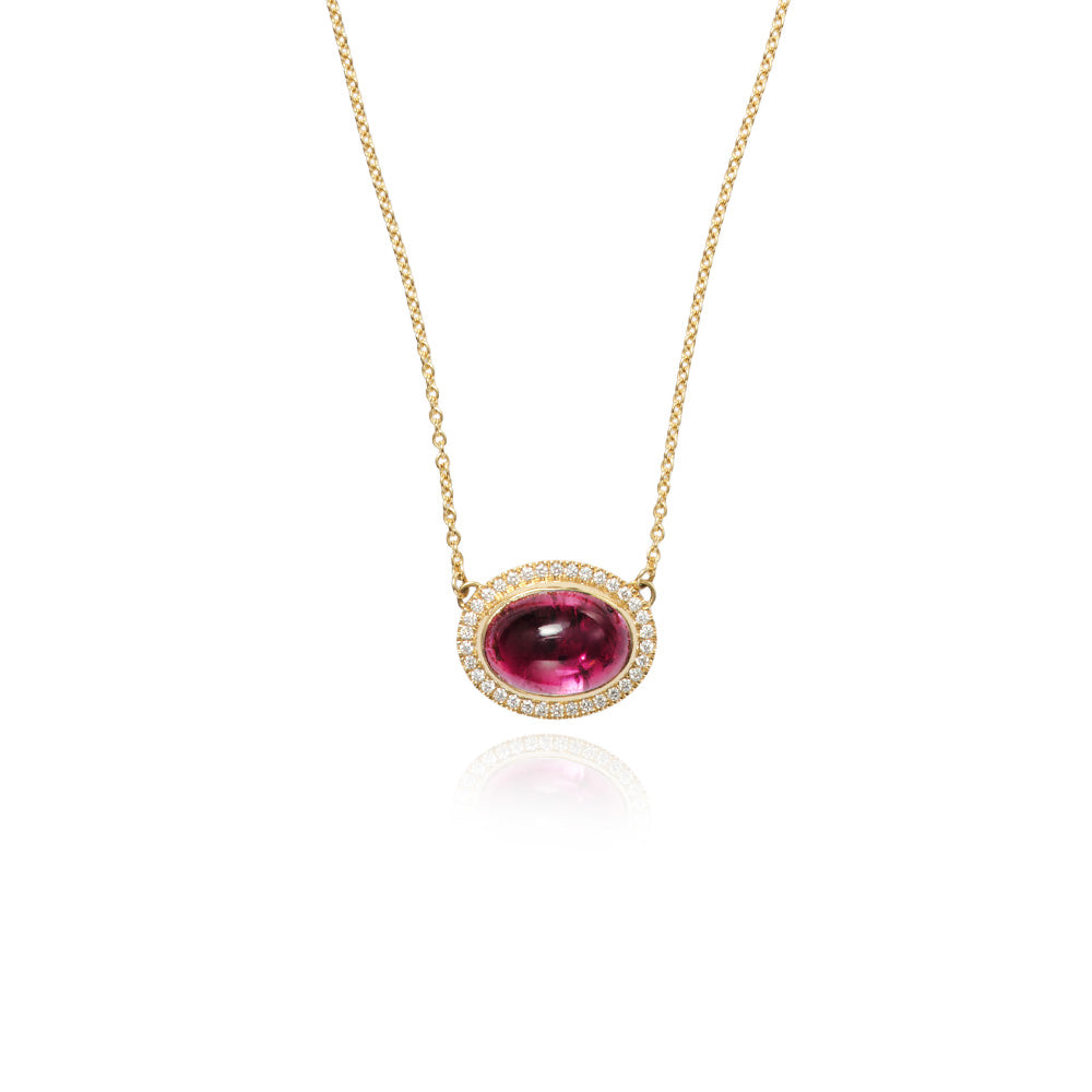 Aurora pendant with an East/West set oval rubellite cabochon surrounded by pavé-set diamonds, 0.35 cttw. Chain is 18k yellow gold with a lobster clasp and is adjustable to 19" long. The pendant is 5/8" x 3/4" (16 x 19mm).