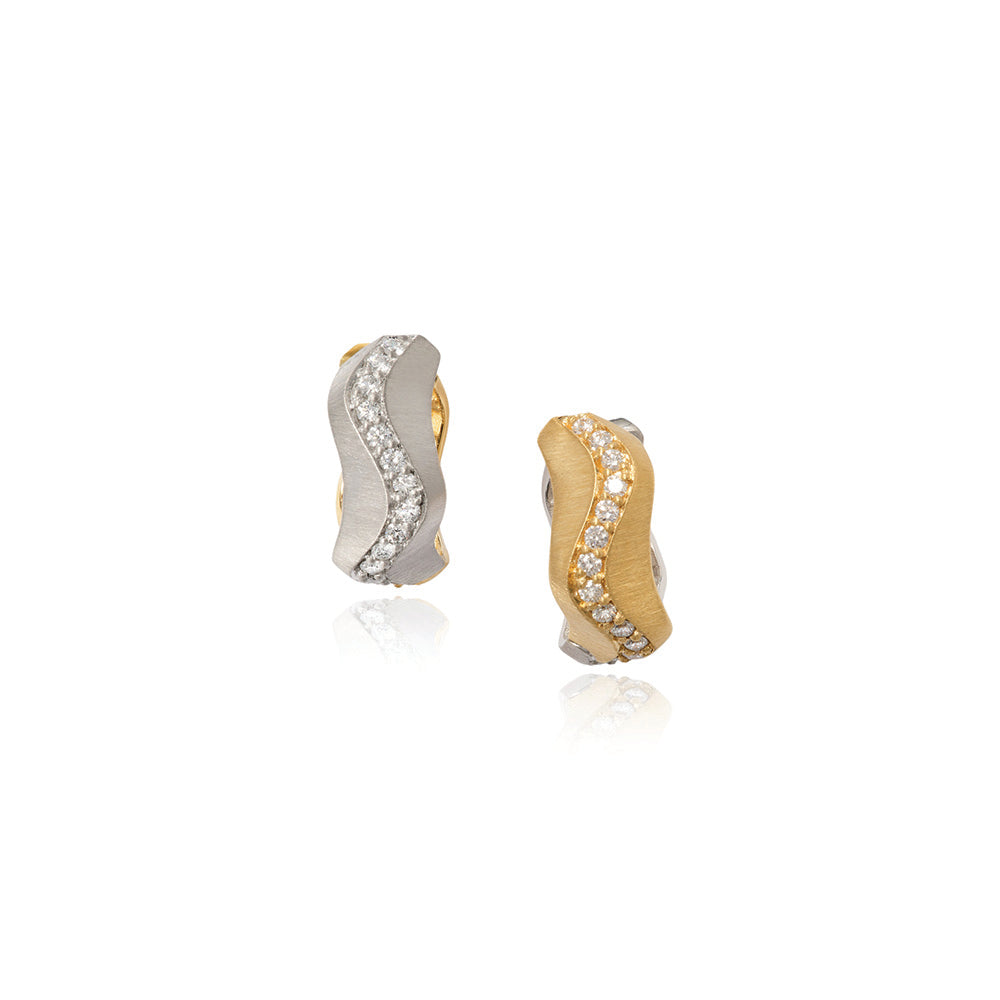 Spur huggie diamond earrings with a reversible lever back setting, one side is 18k yellow gold and the other side is 18k white gold with pavé-set diamonds on both sides, .72 cttw, with a heavy silk finish. Earrings are 1/4" wide x 5/8" diameter (6 x 16mm).