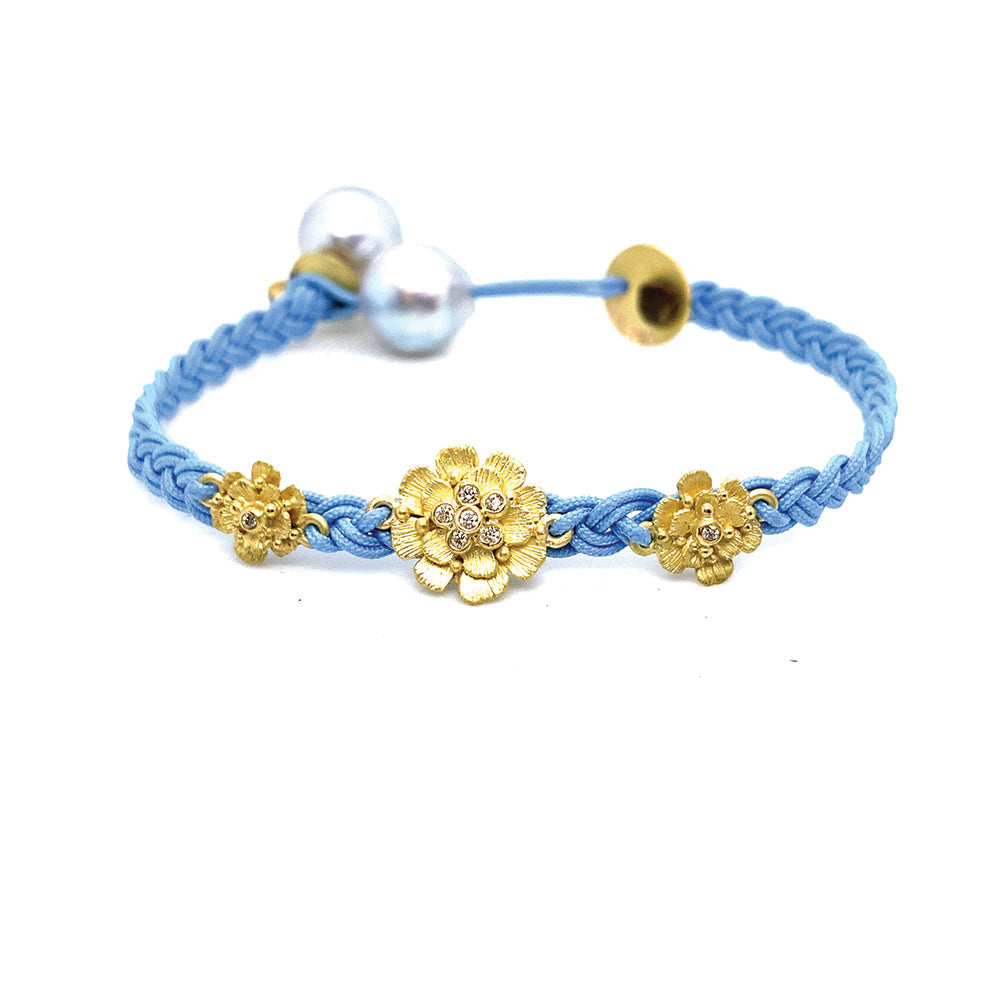 sky blue woven bracelet with flowers and tahitian pearls