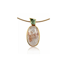oval quartz pendant with quartz and iron inclusions with green tourmalinee