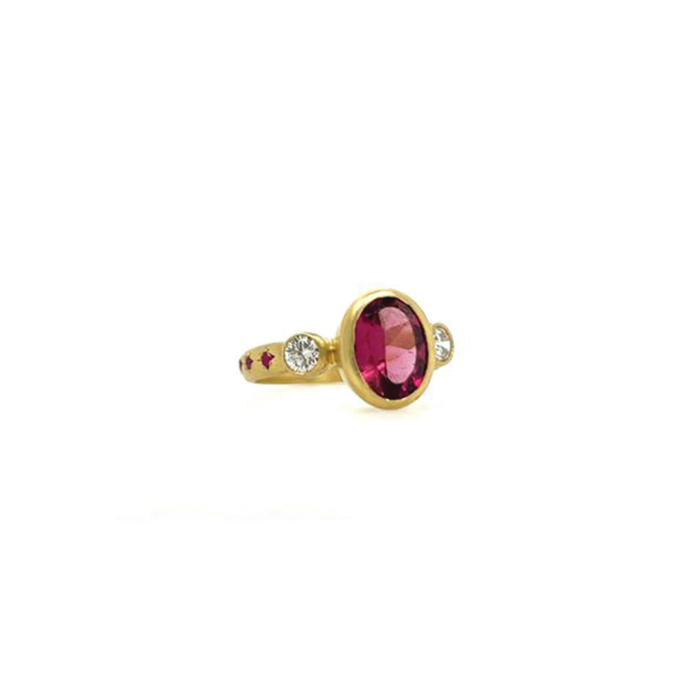 Three-stone ring with rubellite tourmaline, champagne diamonds, and pink sapphires